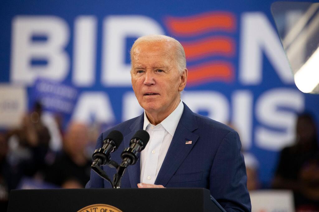 An image of President Biden in front of microphones
