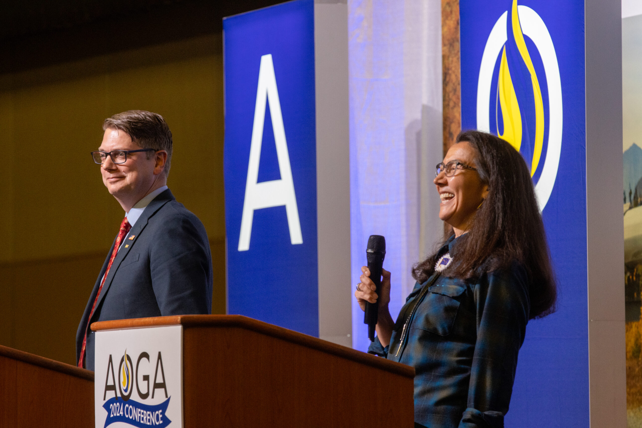 a female laughing and man opinionated adjacent to her