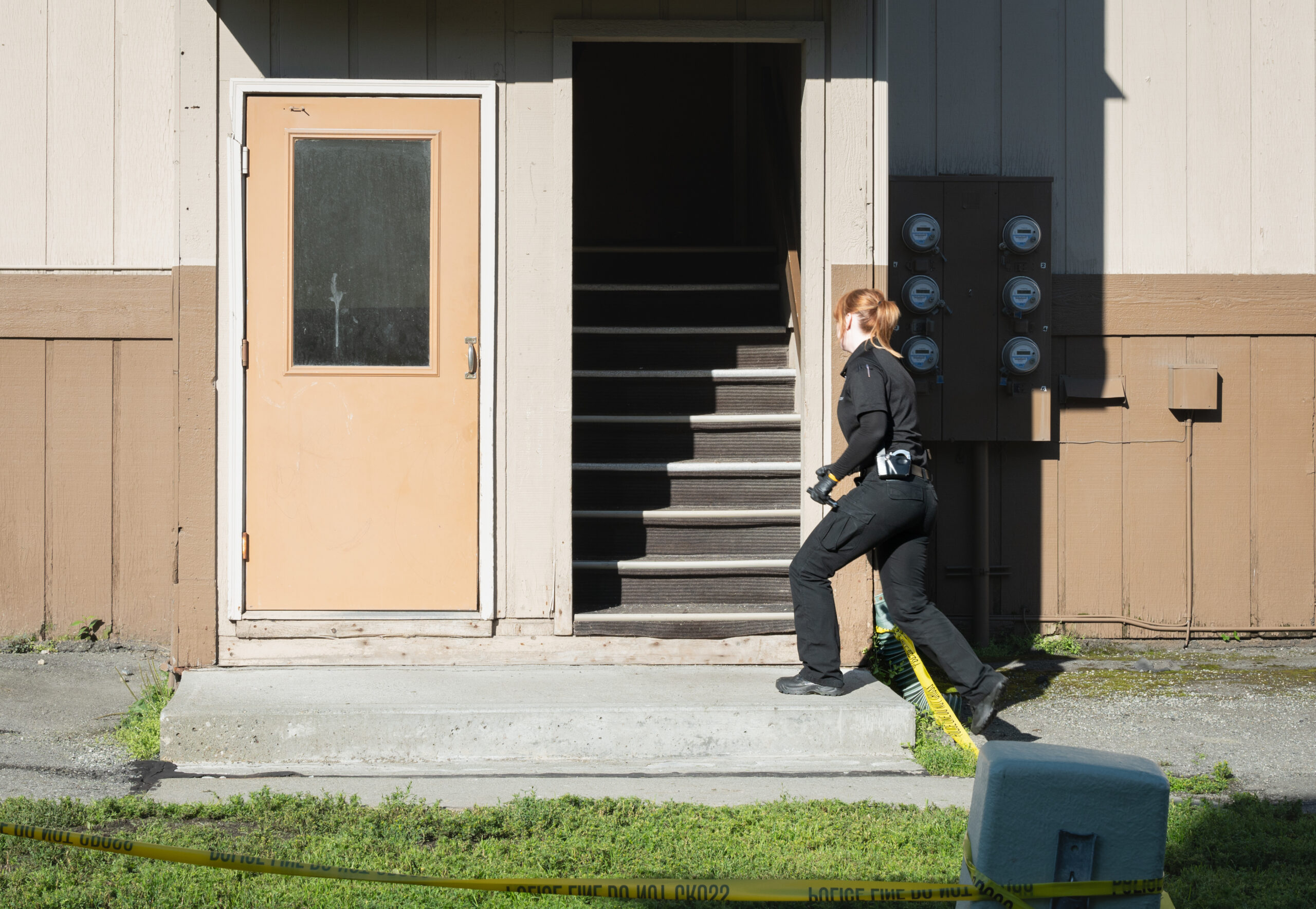 A Police officer walks towards a flight of stairs.