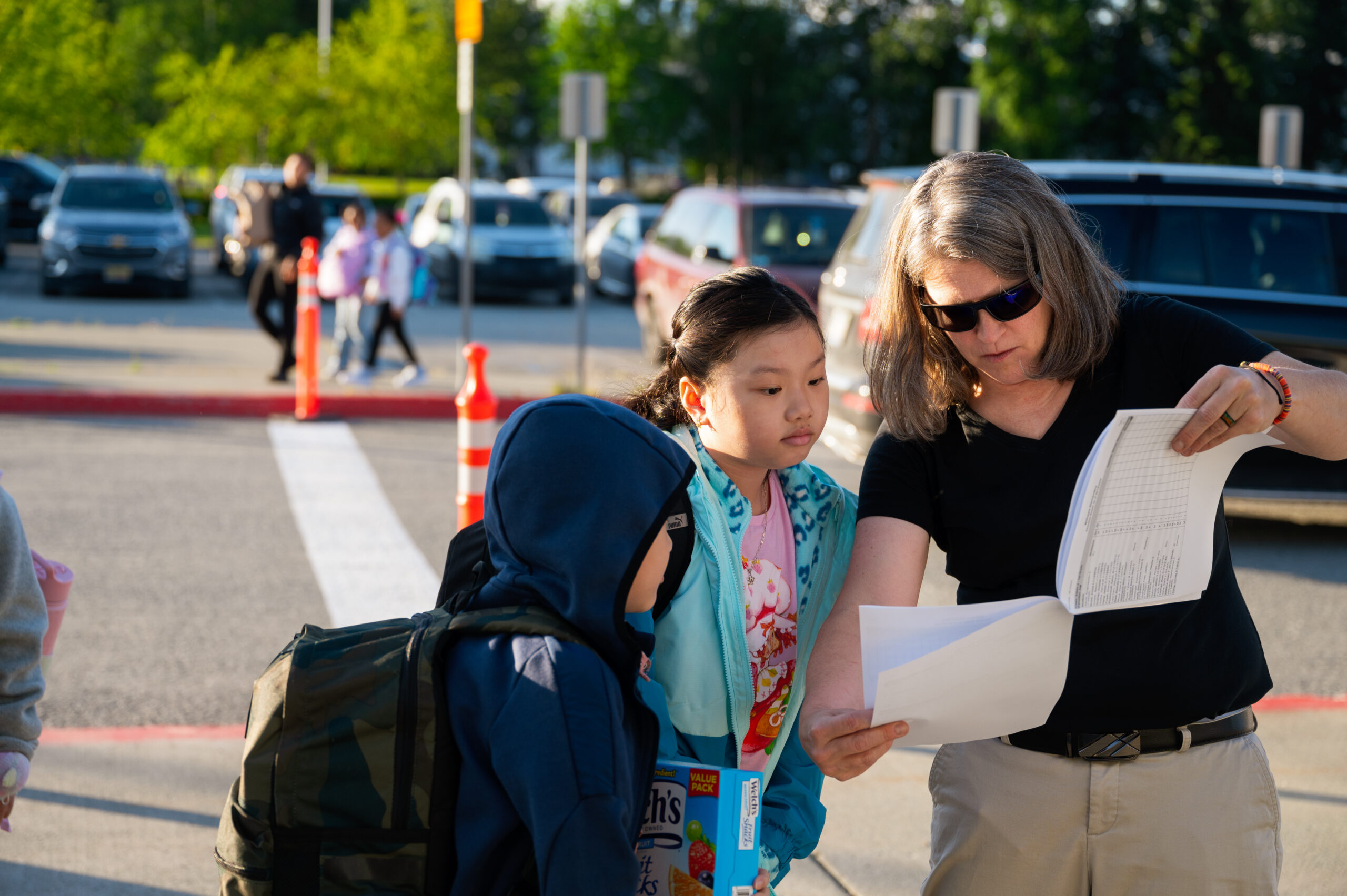 A female helping students find their classes.