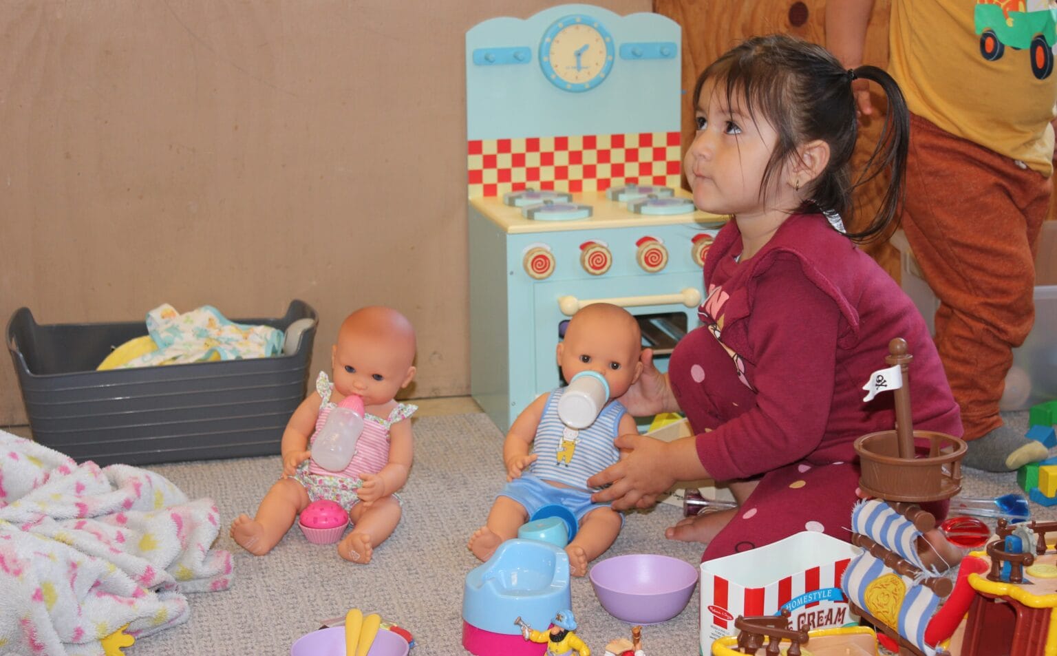 a child playing with dolls