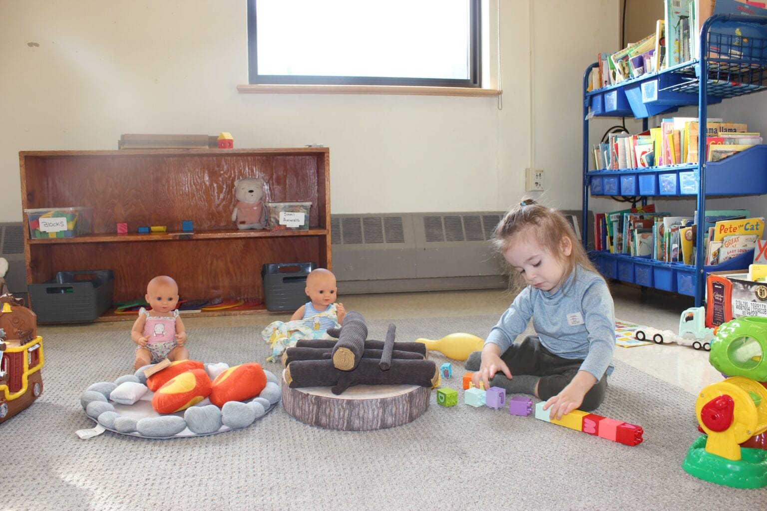 a child playing with dolls