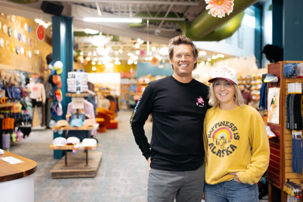 A man and a woman stand in a running store. 