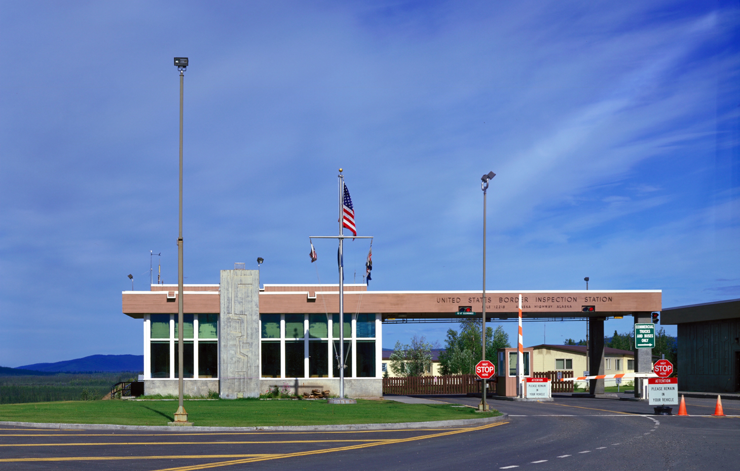 a building that says agreed states separator inspection position connected it has an land emblem successful beforehand and 2 extremity signs and signs instructing commercialized trucks and buses to spell successful a circumstantial lane.