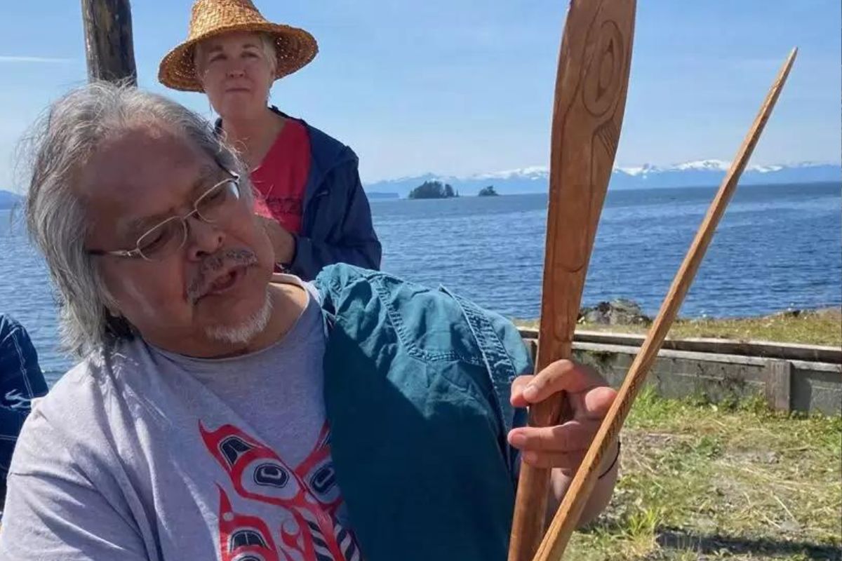 a man holds paddles outside