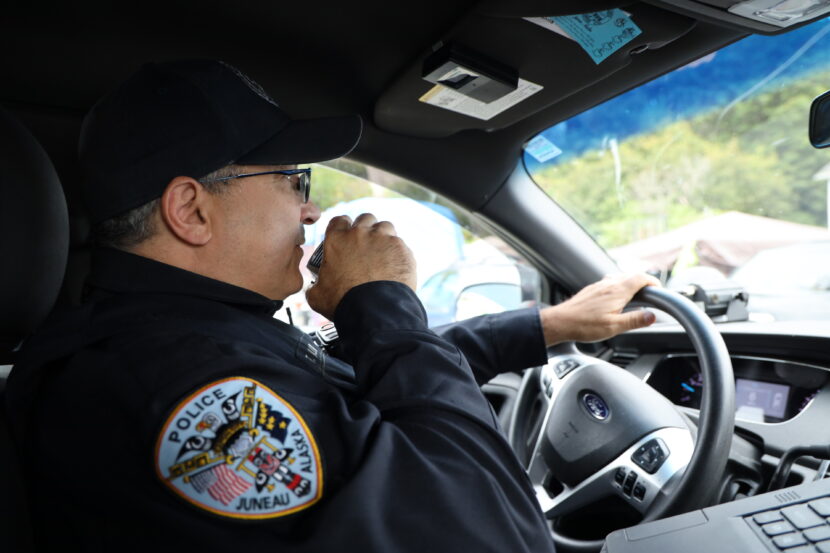 a constabulary serviceman talking connected a power successful a car