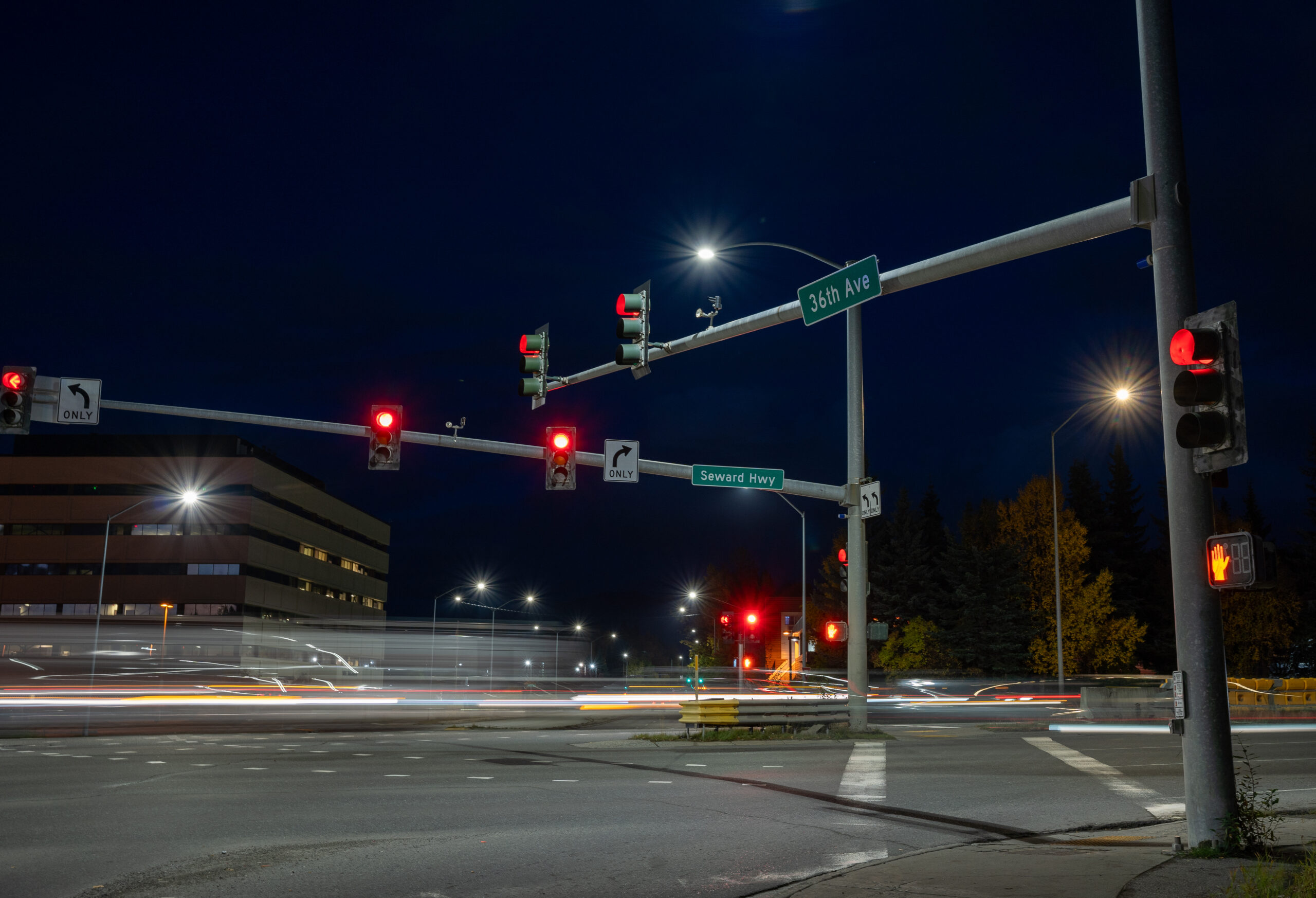 Street lights with cars going by.