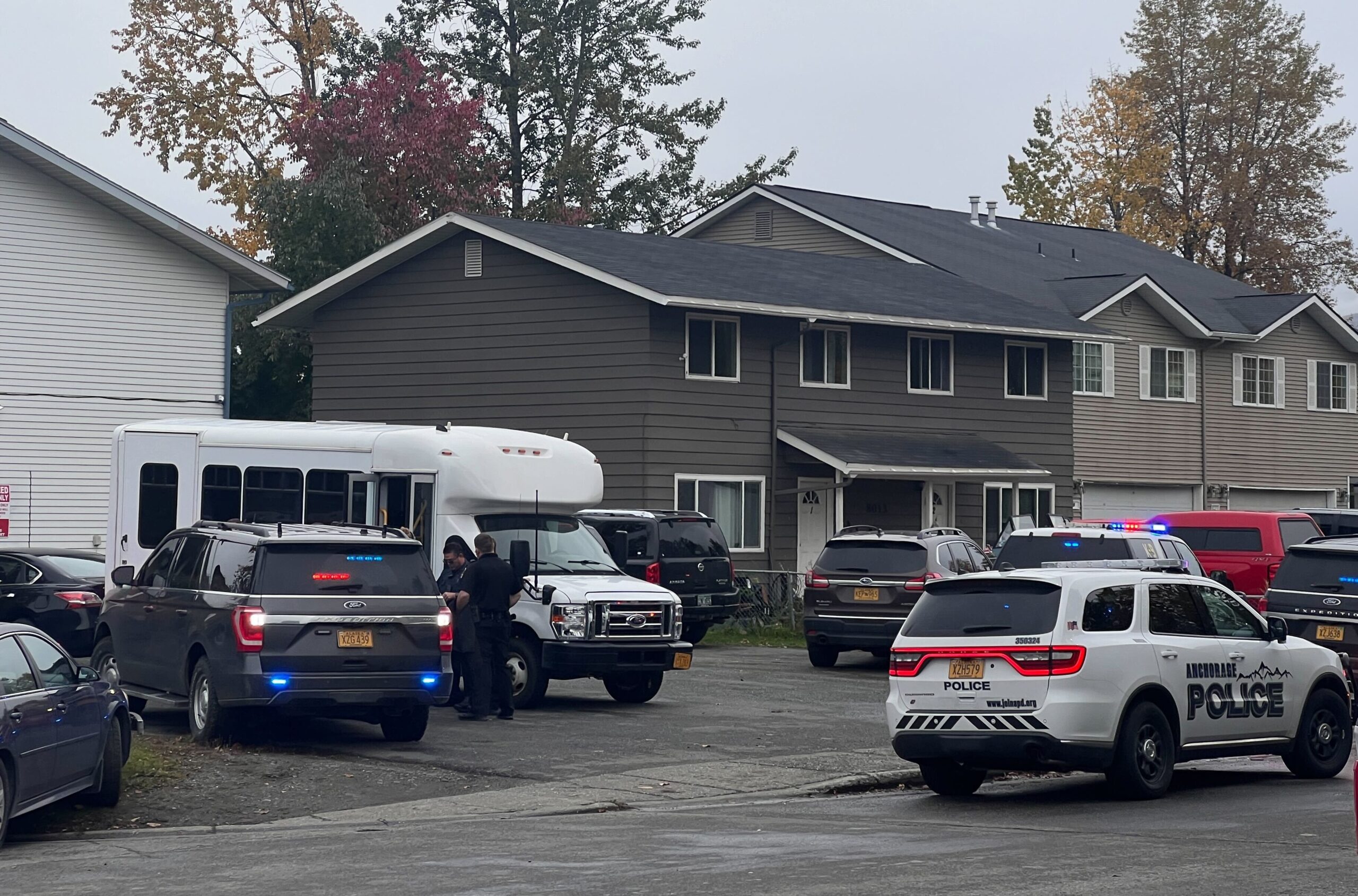 police cars adjacent beige homes