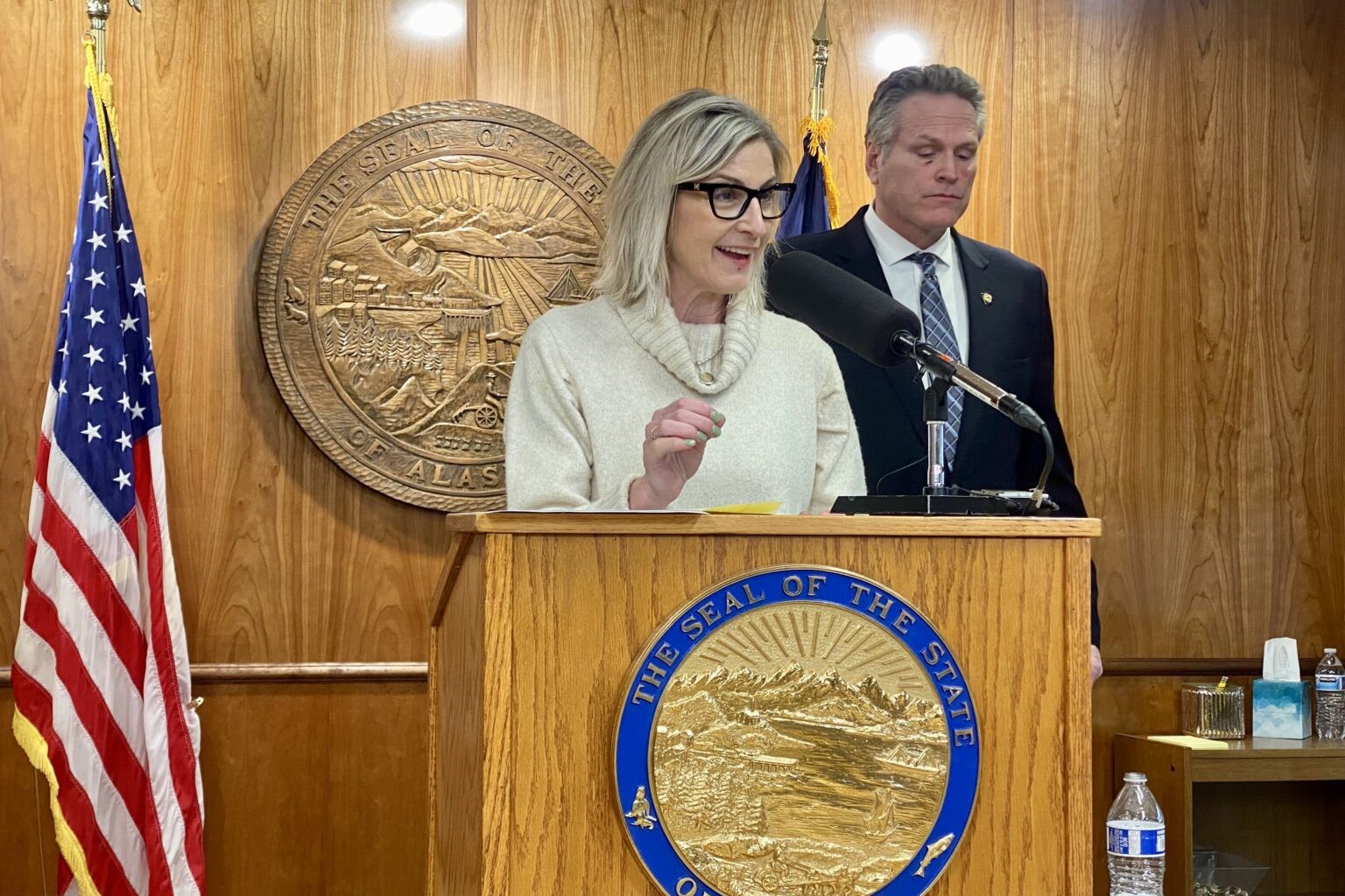 a woman speaks behind a podium