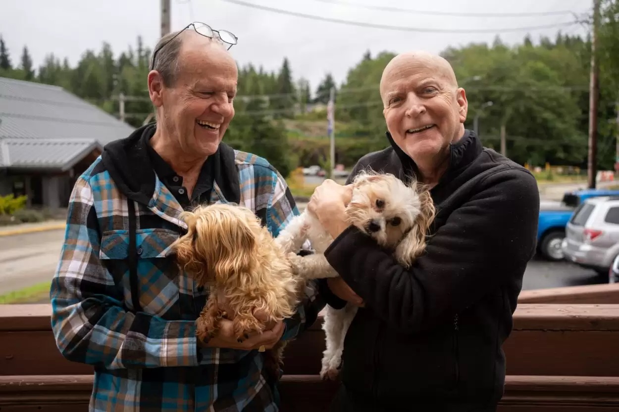 two men with dogs