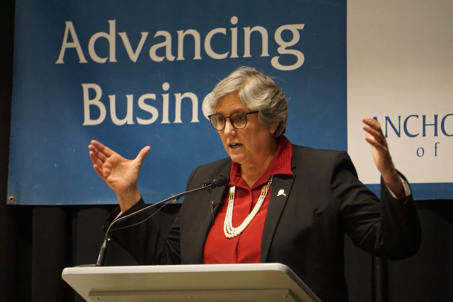 a female opinionated down a lectern