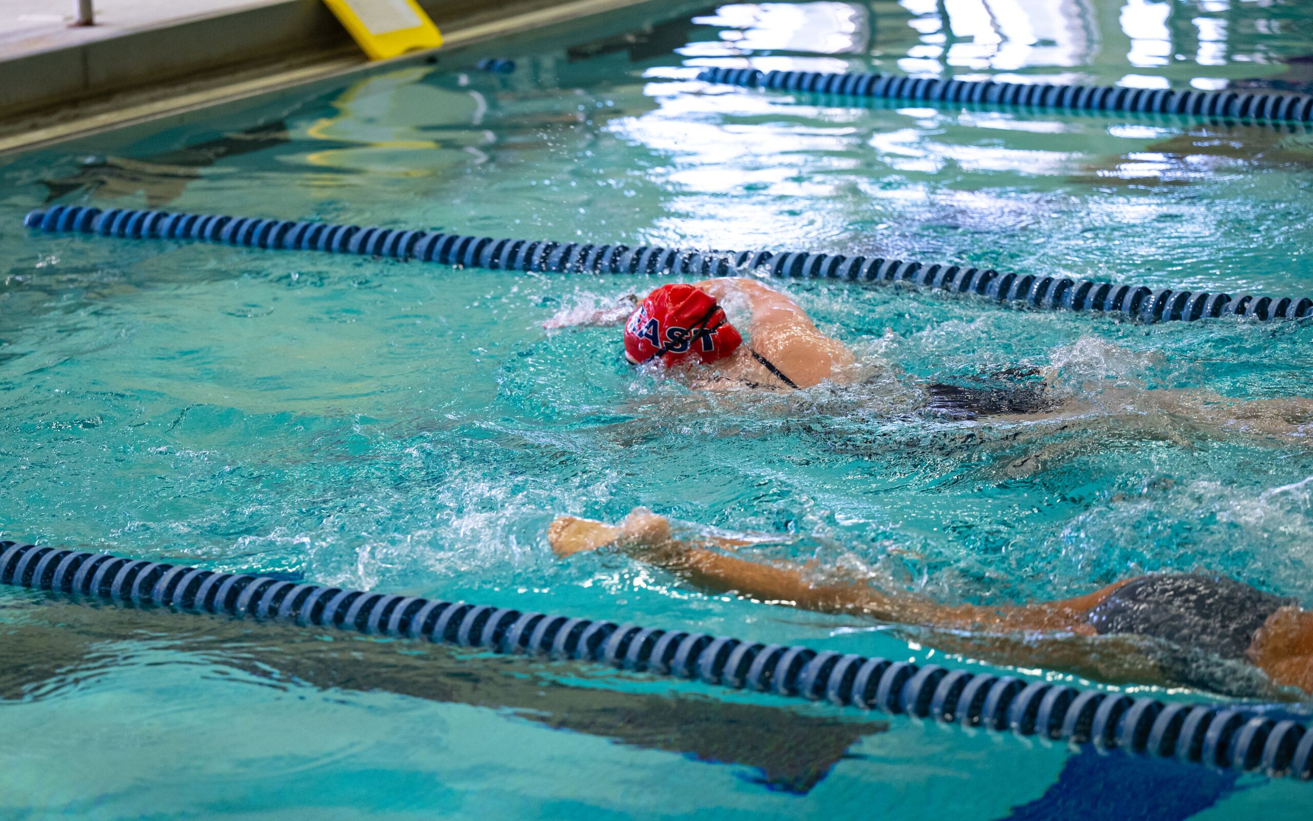 High school students in a swimming pool.