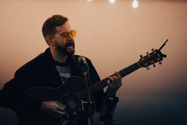 A man plays an acoustic guitar. 