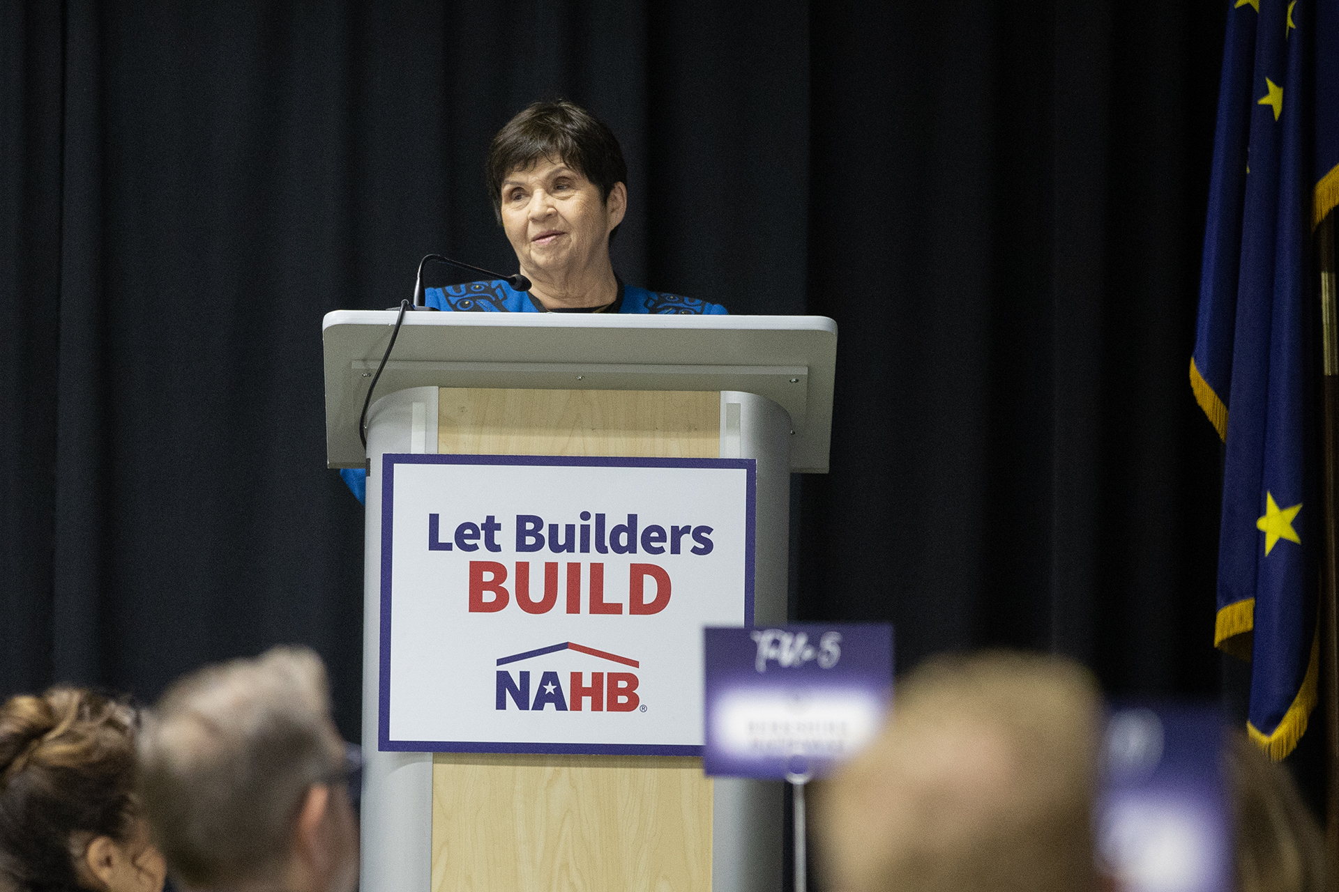 a lady speaking at a podium