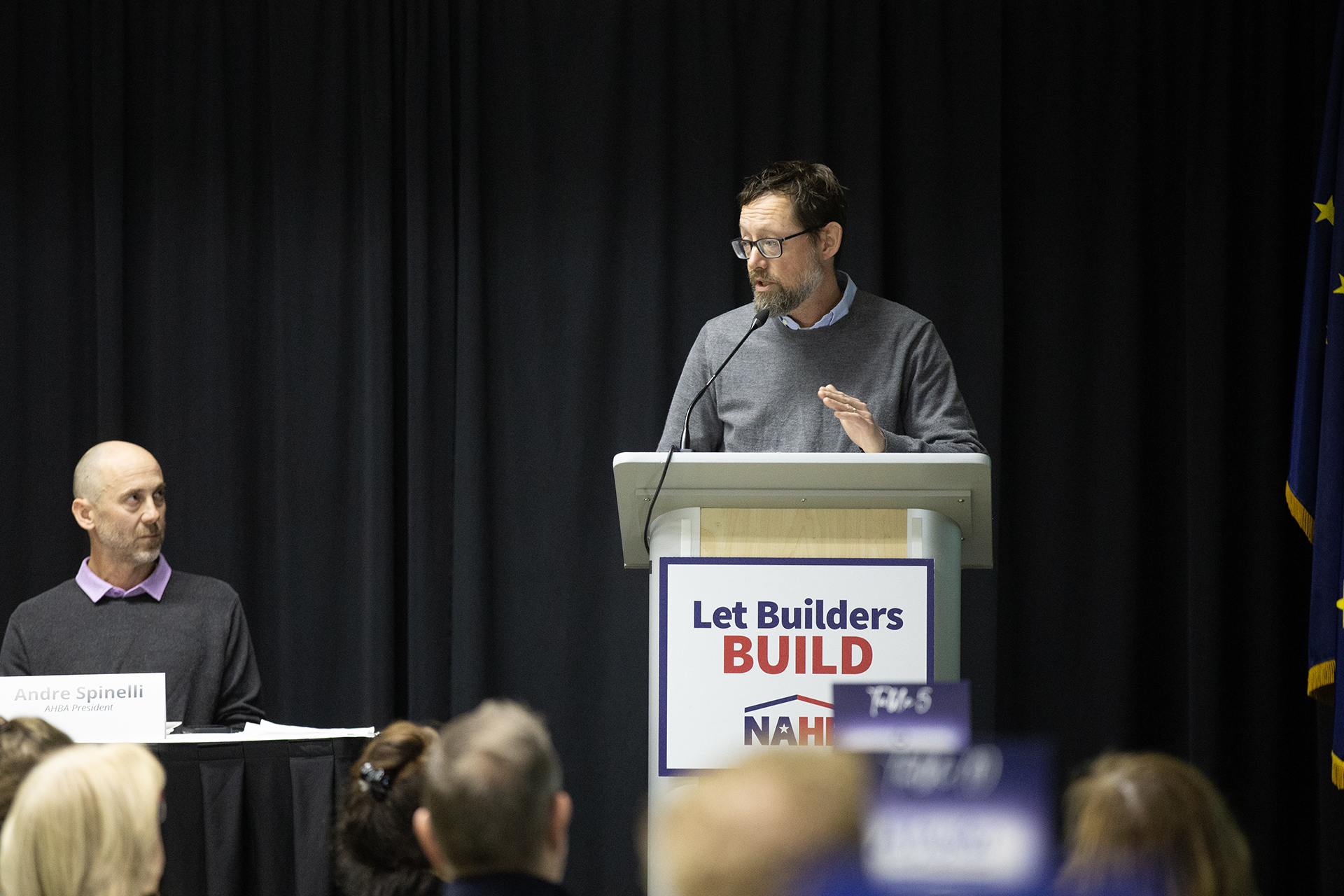 a man speaking at a podium