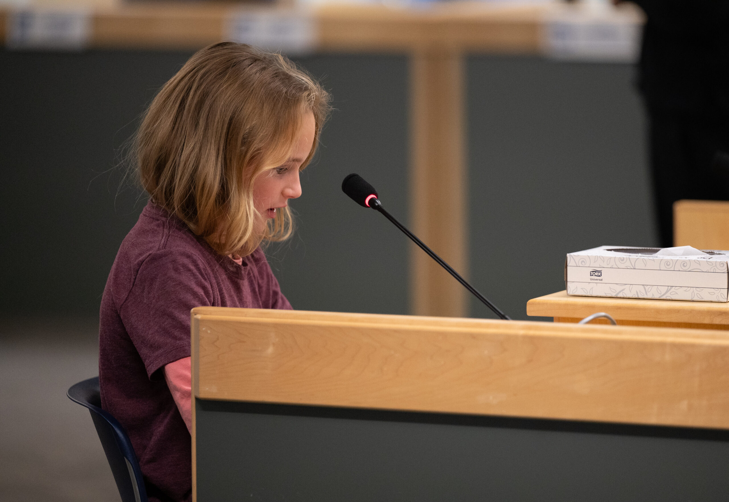 A girl speaks at the podium during an Anchorage School Board meeting.