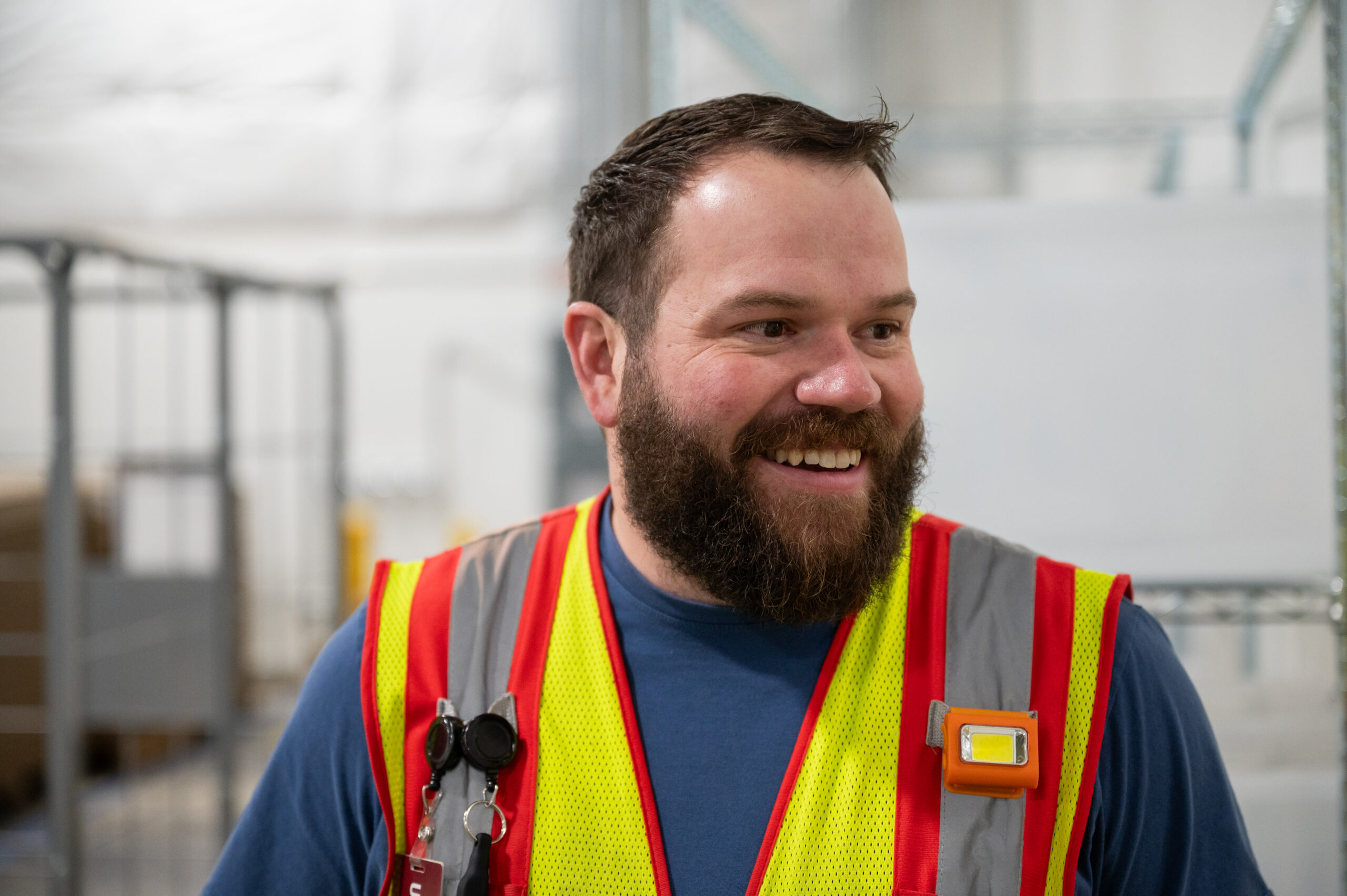 A man smiling in a safety vest