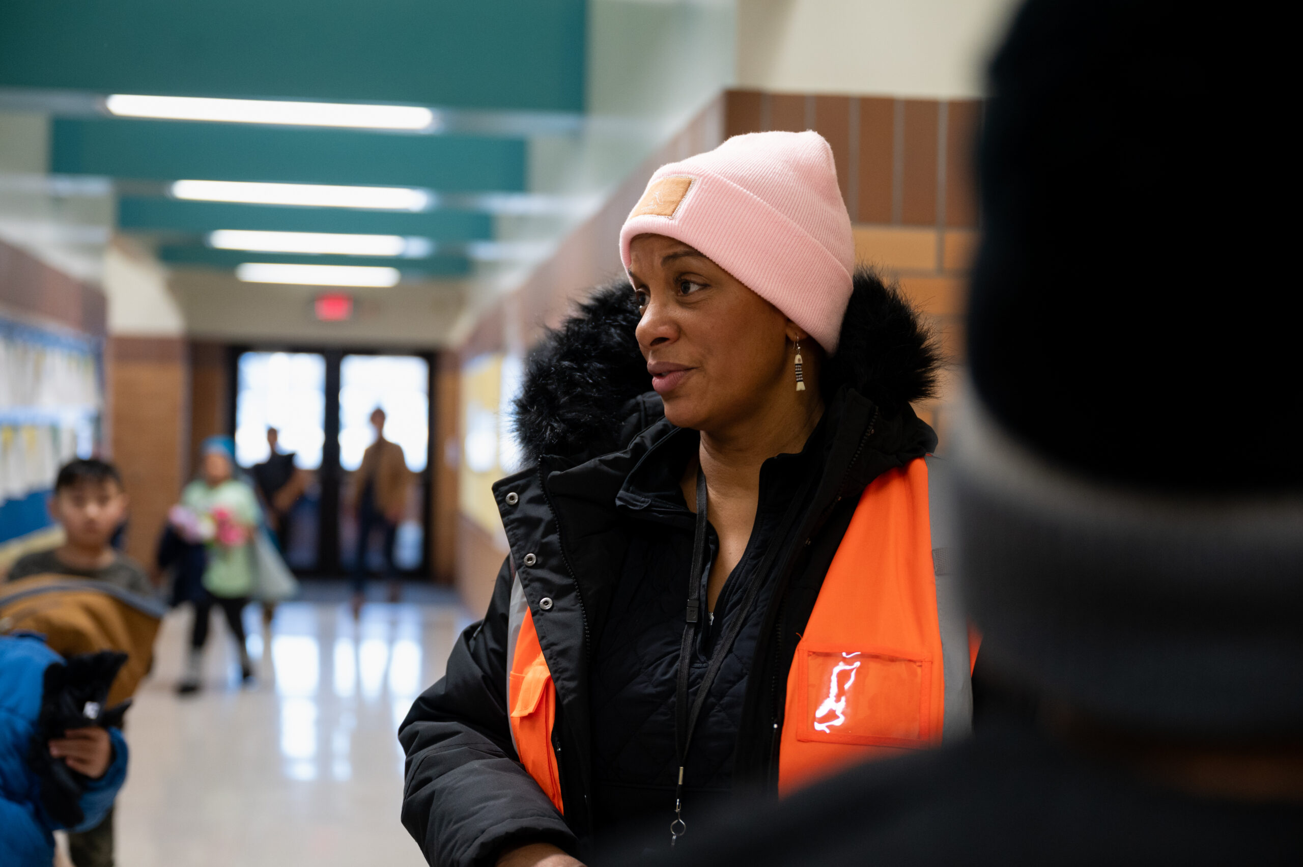 A woman in an orange safety vest.