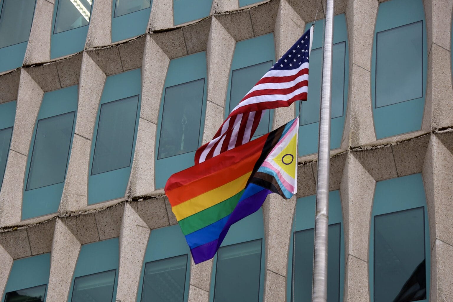 An American flag and LGBTQ+ flag 