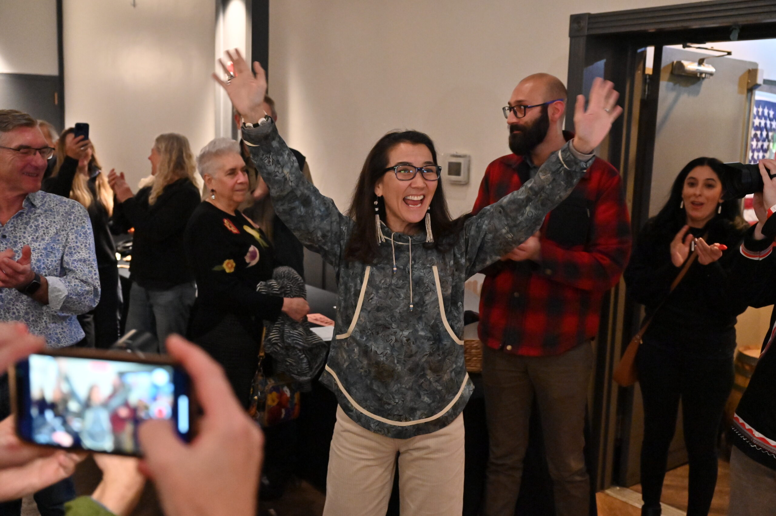 a woman greets a room