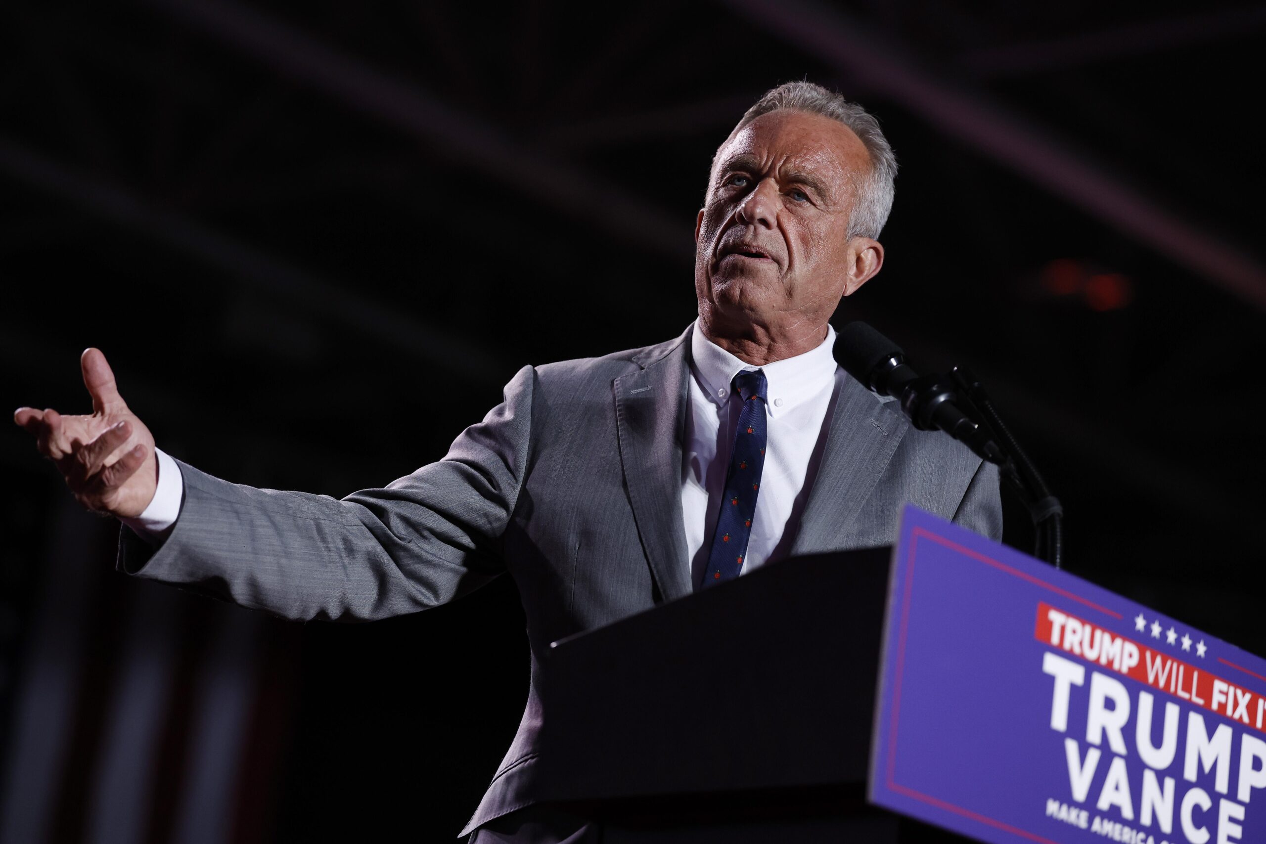 a man in a suit at a podium