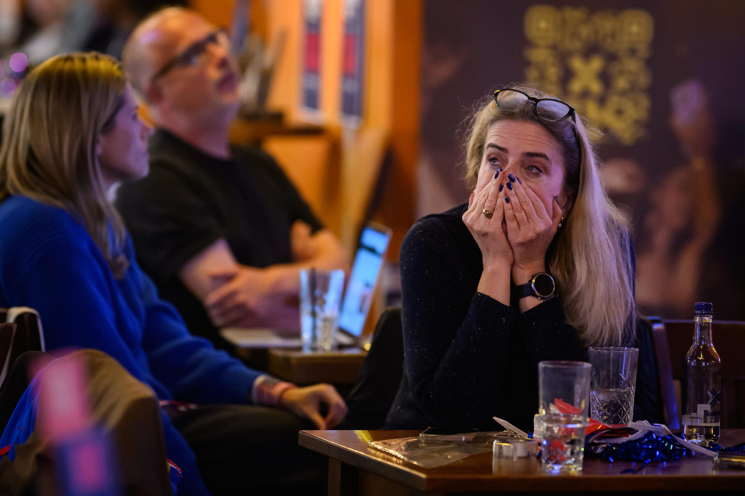 a woman with her hands over her mouth